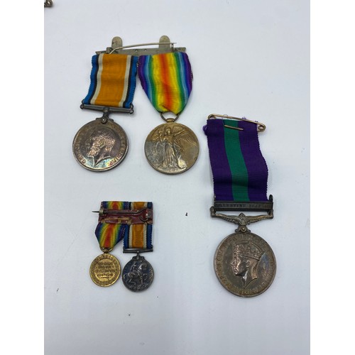 166 - A collection of medals and cap badges. WWI medals to Pte J. Cross.