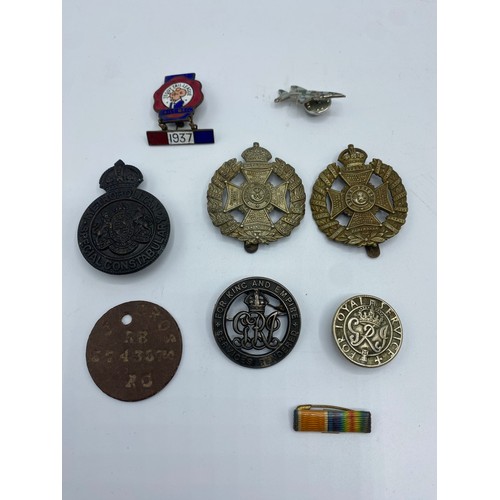 166 - A collection of medals and cap badges. WWI medals to Pte J. Cross.