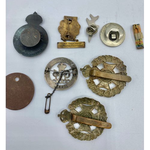 166 - A collection of medals and cap badges. WWI medals to Pte J. Cross.