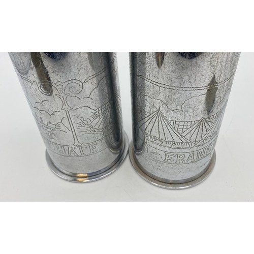 167 - A collection of WWI trench art to include a pair of white metal German shell case vases dated 1914.