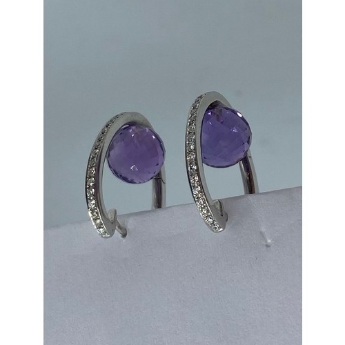 149 - A pair of 18ct white gold amethyst and diamond ear rings. 6.8g.