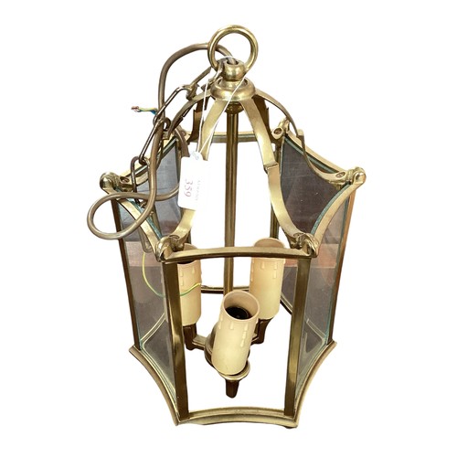 211 - A six panel brass and glass hanging hall lantern, and three brass twin branch wall sconces