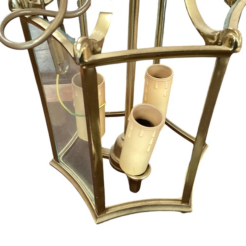 211 - A six panel brass and glass hanging hall lantern, and three brass twin branch wall sconces