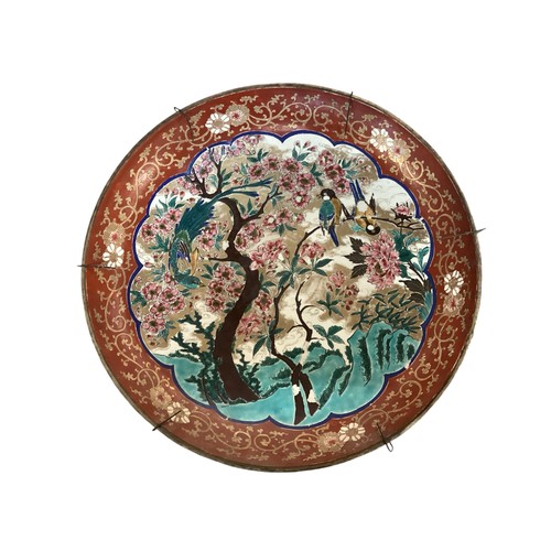 215 - A large Japanese charger, 37.5cm diameter, decorated trees and birds, and verso rim with foliage, as... 