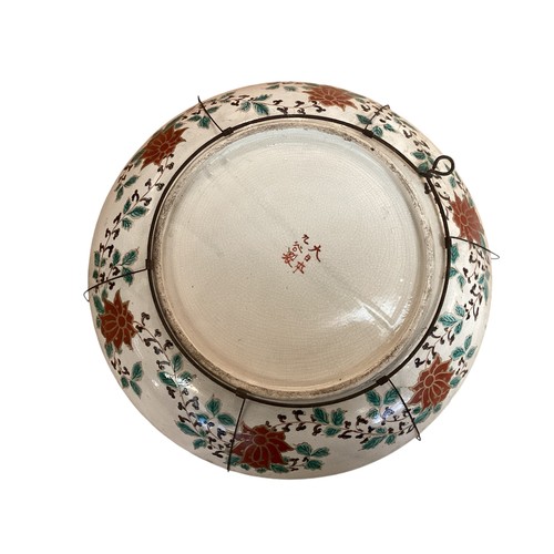 215 - A large Japanese charger, 37.5cm diameter, decorated trees and birds, and verso rim with foliage, as... 