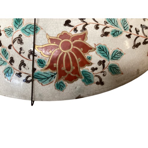 215 - A large Japanese charger, 37.5cm diameter, decorated trees and birds, and verso rim with foliage, as... 