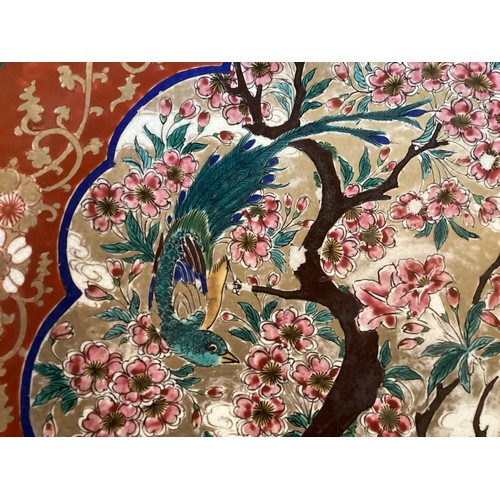 215 - A large Japanese charger, 37.5cm diameter, decorated trees and birds, and verso rim with foliage, as... 