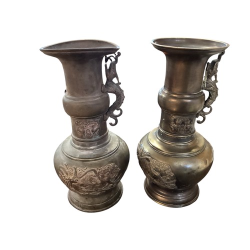 224 - A pair of Chinese bronze urn alter pieces, each urn with raised dragon decoration, 31cm High