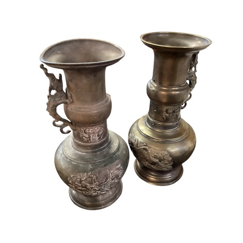 224 - A pair of Chinese bronze urn alter pieces, each urn with raised dragon decoration, 31cm High