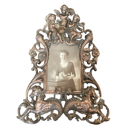 221 - A vintage bronze effect ornate frame with cherub and sea horses, approx 34cm High