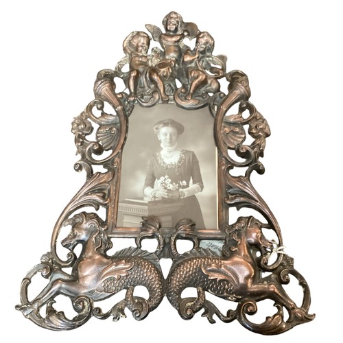 221 - A vintage bronze effect ornate frame with cherub and sea horses, approx 34cm High