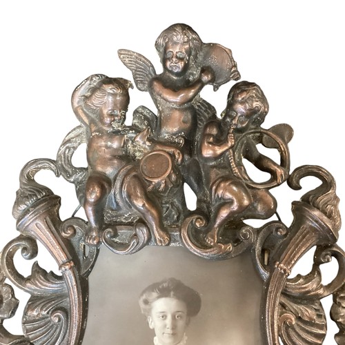 221 - A vintage bronze effect ornate frame with cherub and sea horses, approx 34cm High