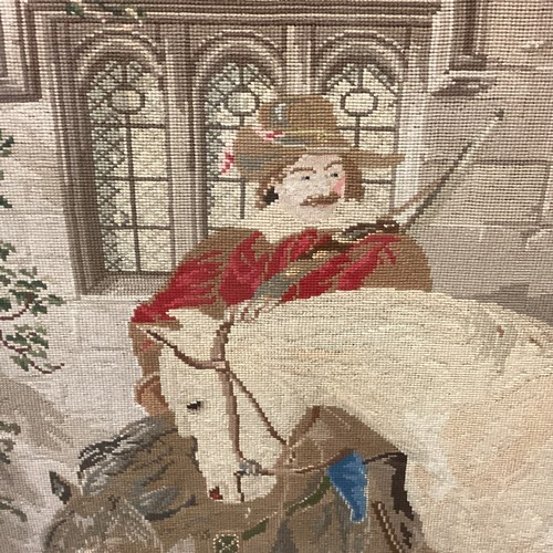 432 - Large framed and glazed tapestry of period courtyard scene of a cavalier man and horse  85cm x 118cm