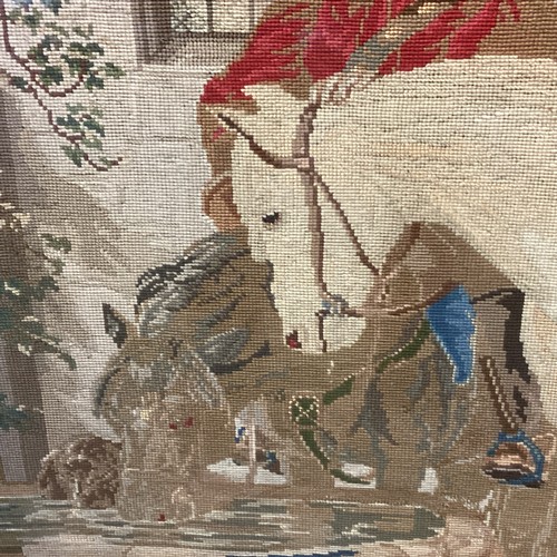 432 - Large framed and glazed tapestry of period courtyard scene of a cavalier man and horse  85cm x 118cm