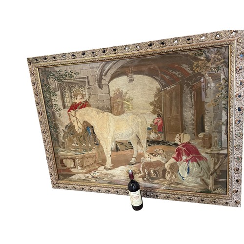 432 - Large framed and glazed tapestry of period courtyard scene of a cavalier man and horse  85cm x 118cm