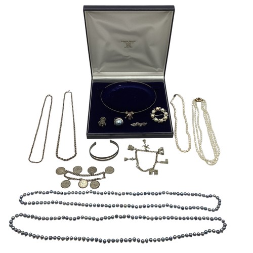 24 - A collection of silver and white metal items to include a sterling silver coin set bracelet, a white... 