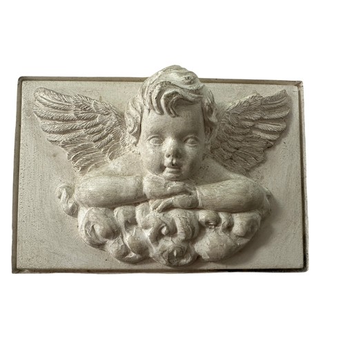 238 - A square stone tile with plaster inset of  winged cherub on a cloud, 18 x 23