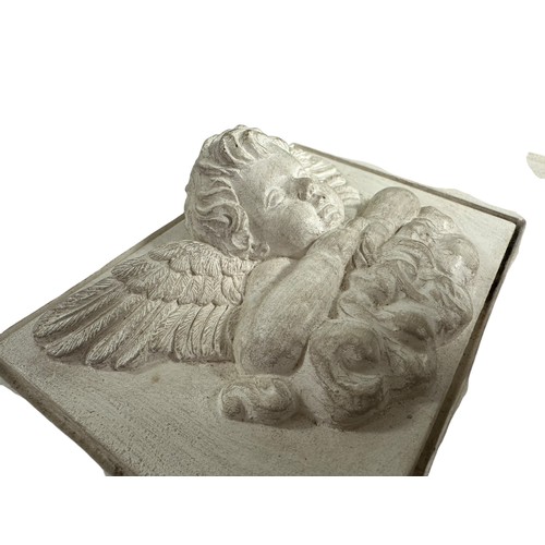 238 - A square stone tile with plaster inset of  winged cherub on a cloud, 18 x 23