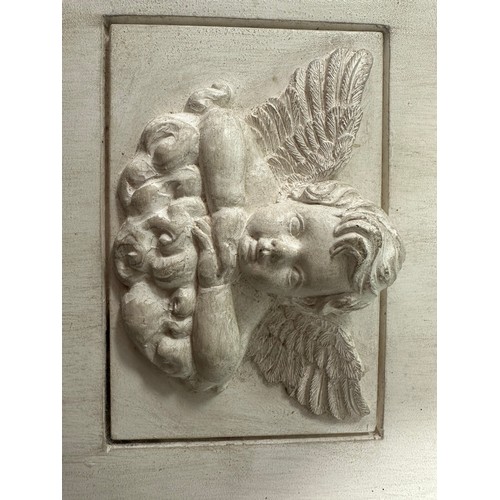 238 - A square stone tile with plaster inset of  winged cherub on a cloud, 18 x 23