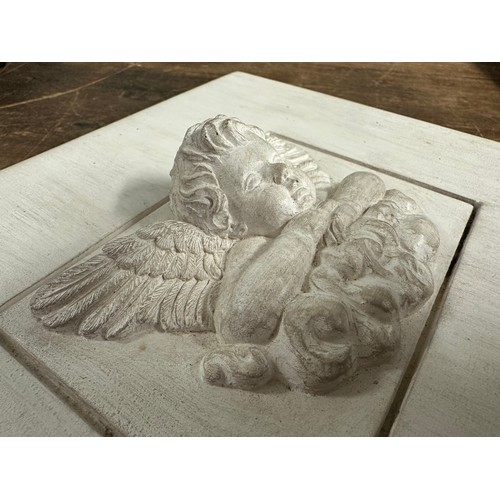 238 - A square stone tile with plaster inset of  winged cherub on a cloud, 18 x 23