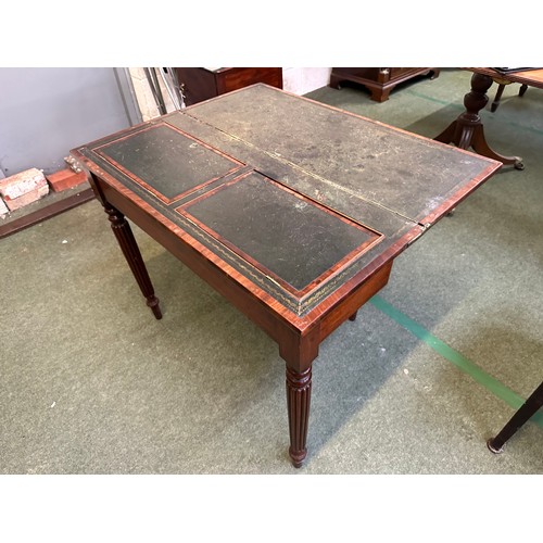 524 - A Regency flame mahogany fold over writing table, opening to reveal green leather fitted interior, s... 