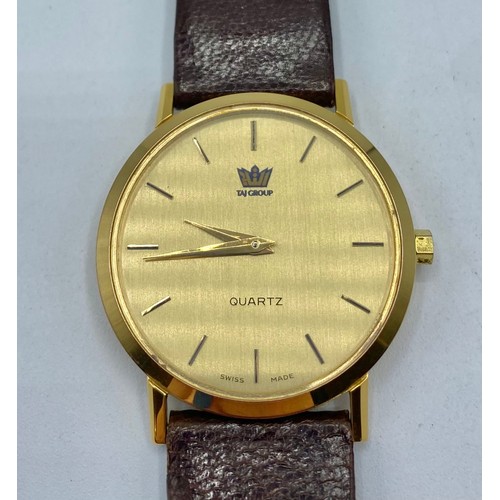 35 - An unmarked yellow metal gentleman's wrist watch Taj Group with quartz movement on red/brown leather... 