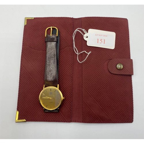 35 - An unmarked yellow metal gentleman's wrist watch Taj Group with quartz movement on red/brown leather... 