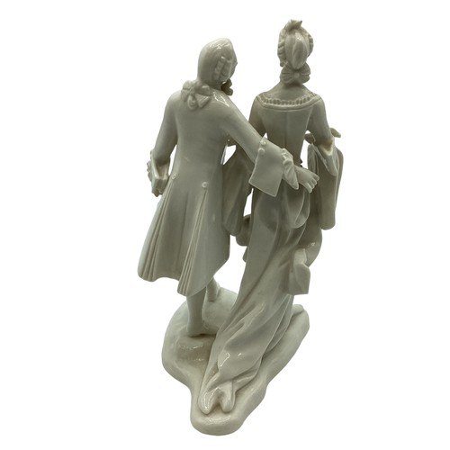 242 - A Nymphenburg, Dresden white porcelain figure group of a man and woman in 19th century dress. Some r... 