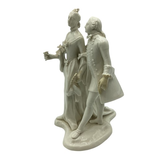 242 - A Nymphenburg, Dresden white porcelain figure group of a man and woman in 19th century dress. Some r... 