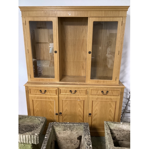 541 - A contemporary oak glazed cabinet, three doors to the base and two glazed door to the top, with shel... 