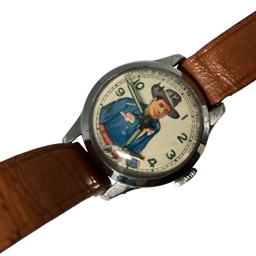 39 - A Vintage 'Roy Rogers' wristwatch. Printed face to white metal case, Moving gun second counter. Muro... 