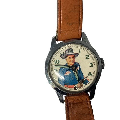 39 - A Vintage 'Roy Rogers' wristwatch. Printed face to white metal case, Moving gun second counter. Muro... 