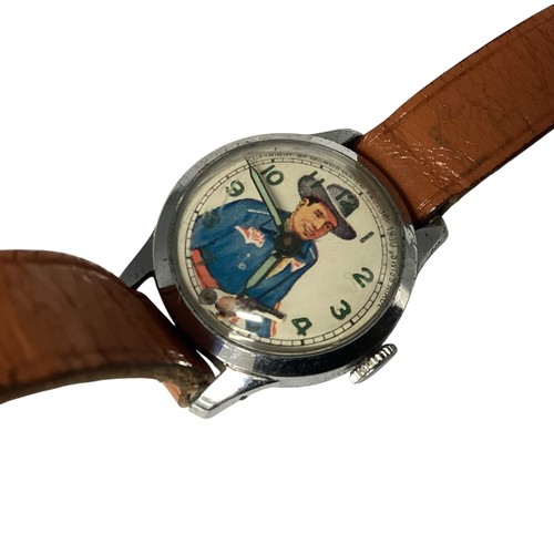 39 - A Vintage 'Roy Rogers' wristwatch. Printed face to white metal case, Moving gun second counter. Muro... 