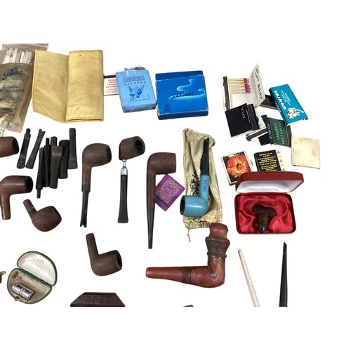 40 - A collection of smoking paraphernalia. Pipes, Ronson lighters cigarette cases etc.