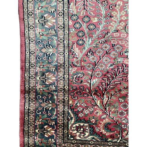 352 - A Kashmir silk rug with pink background and blue and pink border and floral pattern, 94cm x 156cm. G... 