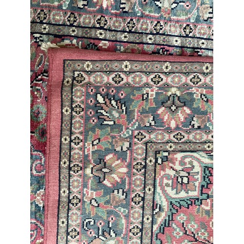 352 - A Kashmir silk rug with pink background and blue and pink border and floral pattern, 94cm x 156cm. G... 