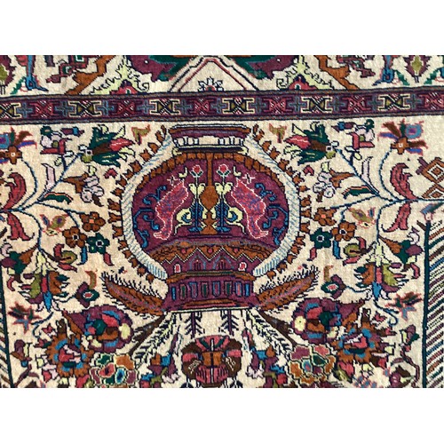 360 - Persian rug, central pattern of flower vases and weeping women and ornate borders with birds. Colour... 