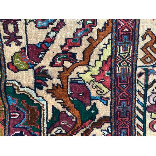 360 - Persian rug, central pattern of flower vases and weeping women and ornate borders with birds. Colour... 