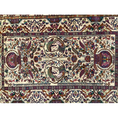 360 - Persian rug, central pattern of flower vases and weeping women and ornate borders with birds. Colour... 