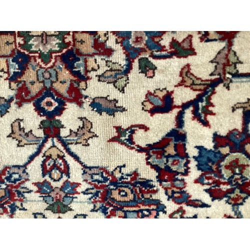 361 - Large Persian wool rug with central ornate pattern and borders. Main colours are cream background wi... 