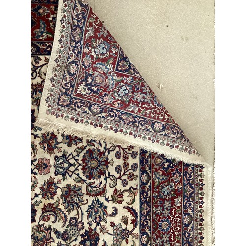 361 - Large Persian wool rug with central ornate pattern and borders. Main colours are cream background wi... 