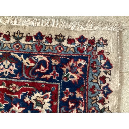 361 - Large Persian wool rug with central ornate pattern and borders. Main colours are cream background wi... 