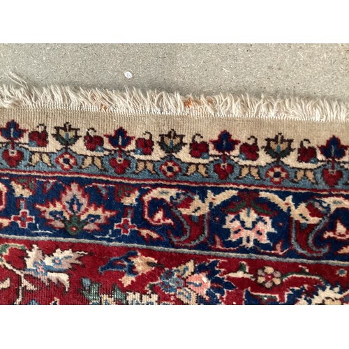 361 - Large Persian wool rug with central ornate pattern and borders. Main colours are cream background wi... 