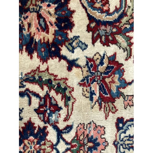 361 - Large Persian wool rug with central ornate pattern and borders. Main colours are cream background wi... 