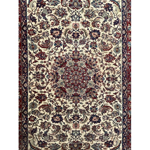 361 - Large Persian wool rug with central ornate pattern and borders. Main colours are cream background wi... 