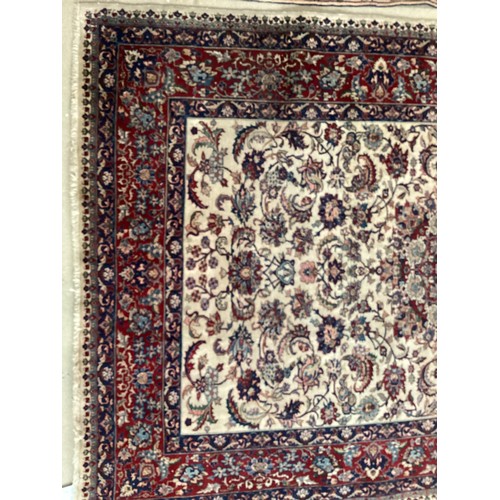 361 - Large Persian wool rug with central ornate pattern and borders. Main colours are cream background wi... 