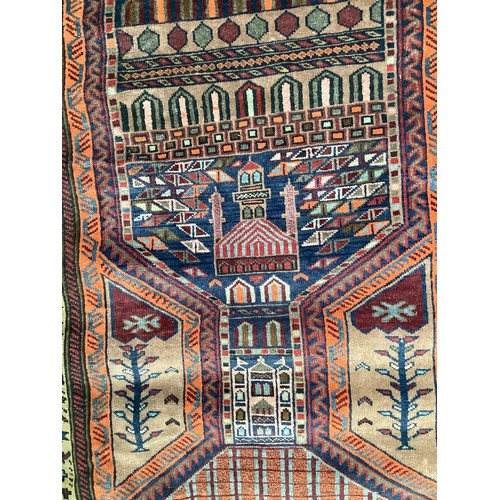 366 - Wool handmade rug with central pattern depicting a temple and border. Main colours are brown, orange... 