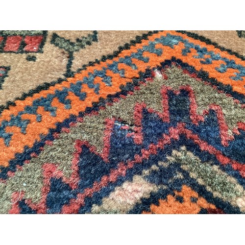 366 - Wool handmade rug with central pattern depicting a temple and border. Main colours are brown, orange... 