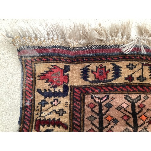 366 - Wool handmade rug with central pattern depicting a temple and border. Main colours are brown, orange... 