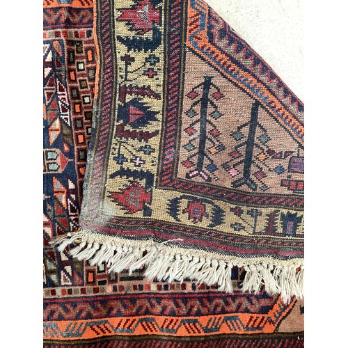 366 - Wool handmade rug with central pattern depicting a temple and border. Main colours are brown, orange... 